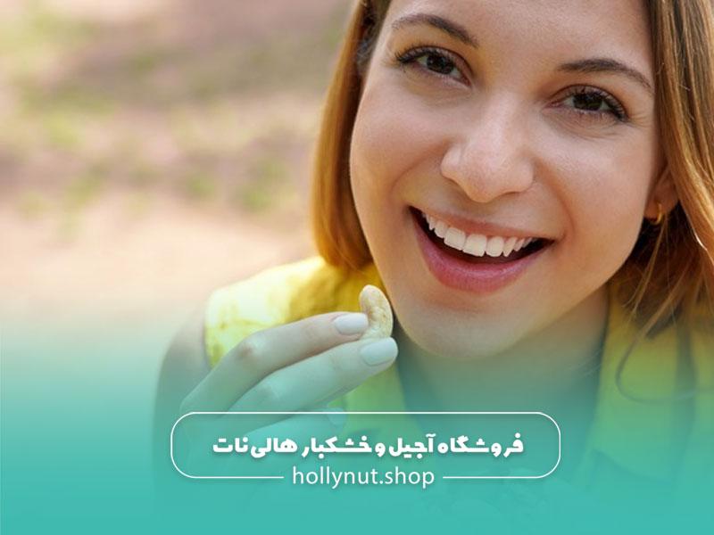 زنی در حال خوردن بادام هندی